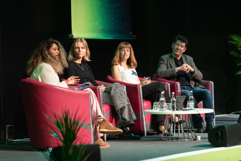 Photo of panellists speaking at The Data Lab’s conference Data Summit 2023, seated left to right: Tricia Govindasamy, Sara Spaargarden, Olga Tokariuk and Dan Klein.