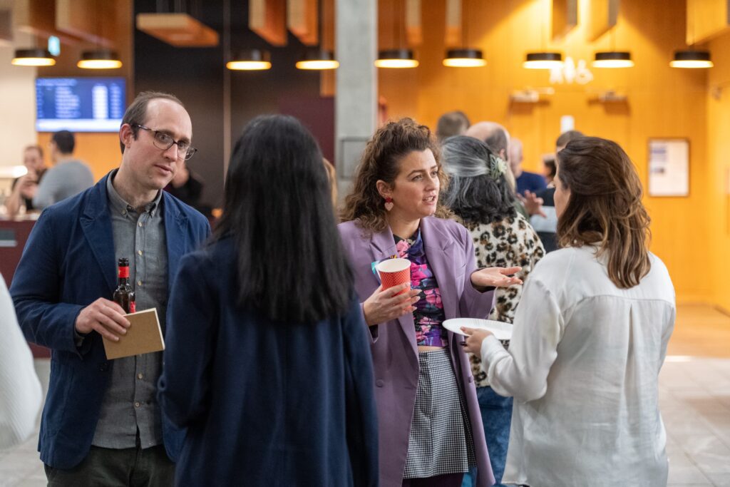A group of four people talking at a Data Lab Community event