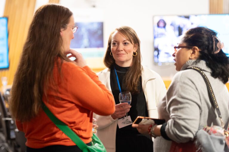 Attendees chatting at The Data Lab's Parliamentary event AI for Good
