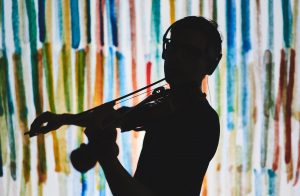 art in data science? silhouette of a violinist with headphones