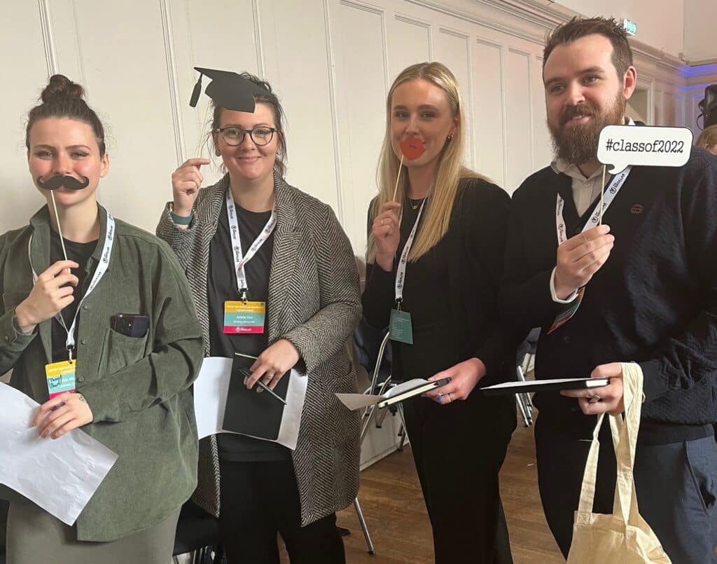 4 data lab academy students holding novelty party sticks