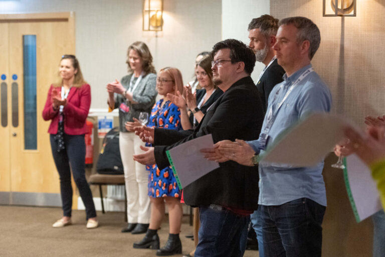 a group of data leaders clapping in a row