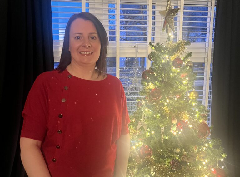 Heather Standing In Front of Christmas Tree
