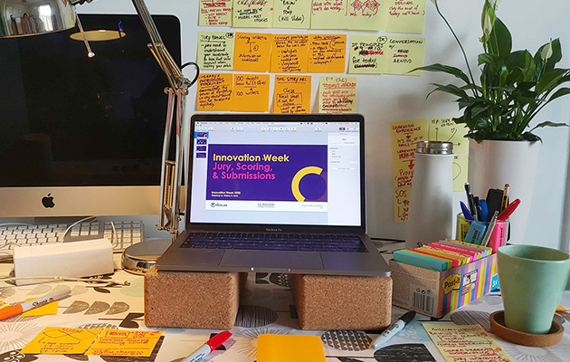 MSc Innovation week - desk with post it notes and laptop