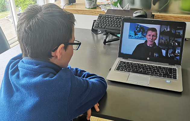 School kid watching live webinar with Tim Peake
