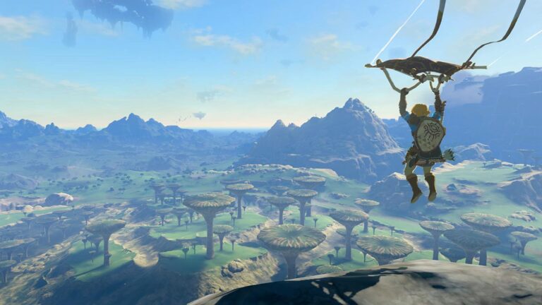 Person flying over village with a parachute glider