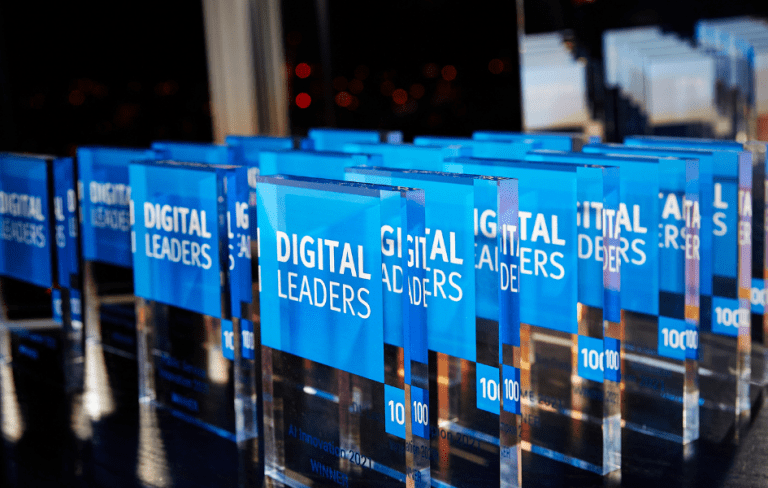 Photo of several blue Digital Leaders awards in a row