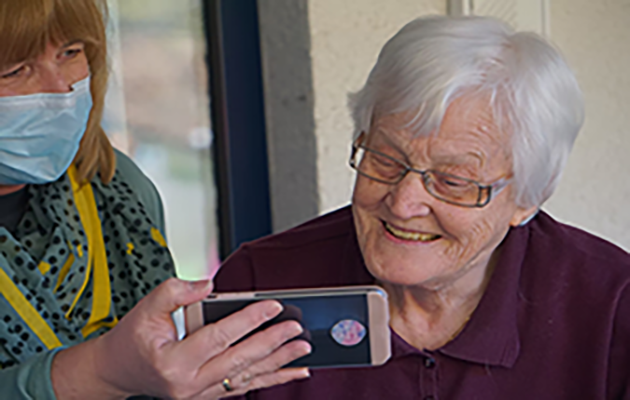 old woman looking at mobile
